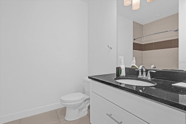 bathroom featuring tile patterned floors, vanity, toilet, and tiled shower