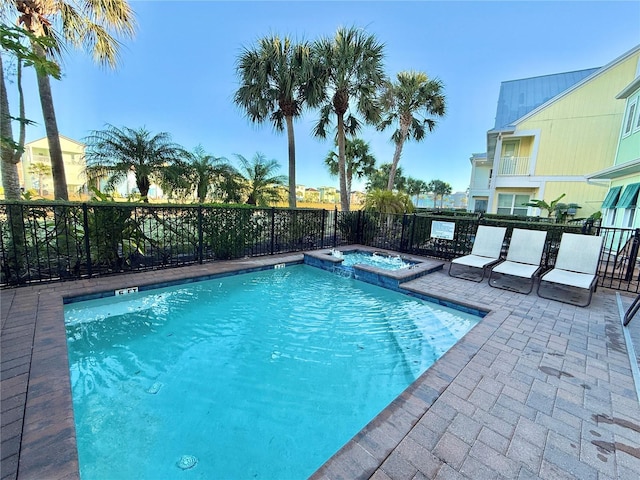 view of pool featuring an in ground hot tub and a patio