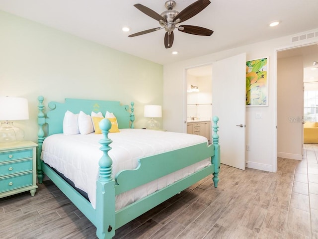 bedroom featuring wood-type flooring, ensuite bath, and ceiling fan