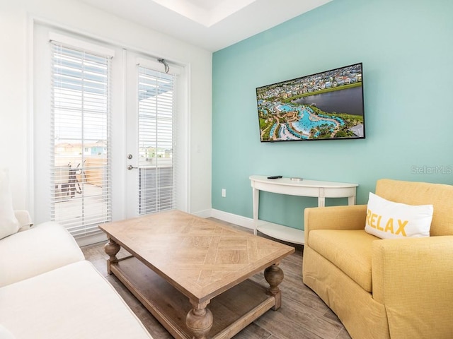 living area featuring baseboards and wood finished floors