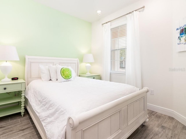 bedroom with dark hardwood / wood-style flooring