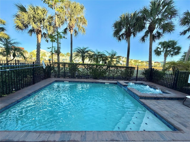 view of pool featuring an in ground hot tub