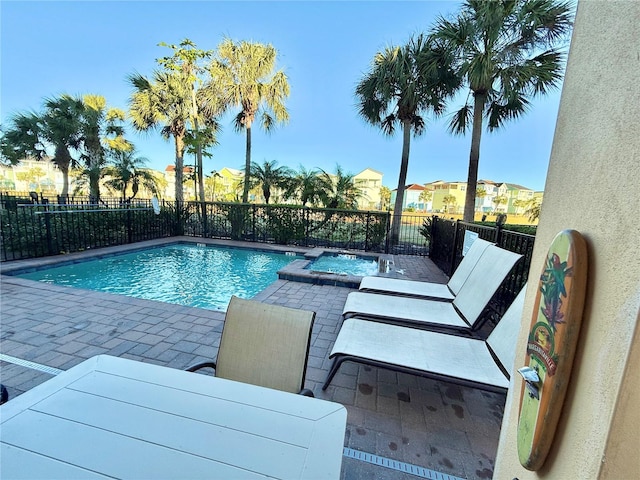 view of swimming pool with an in ground hot tub and a patio