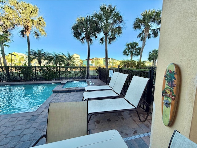 view of pool featuring a patio area and an in ground hot tub