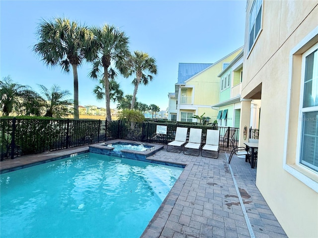 view of swimming pool with a patio area and an in ground hot tub