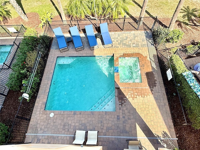 view of swimming pool with fence and a patio