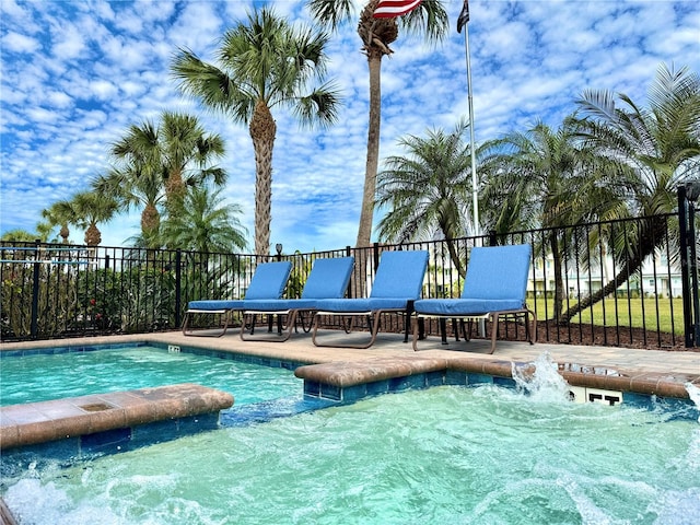 pool with a patio and fence