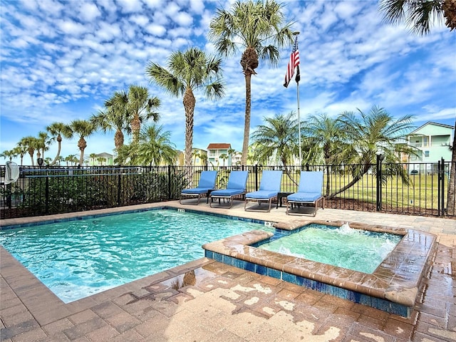 view of pool featuring a fenced in pool, a community hot tub, a patio area, and fence