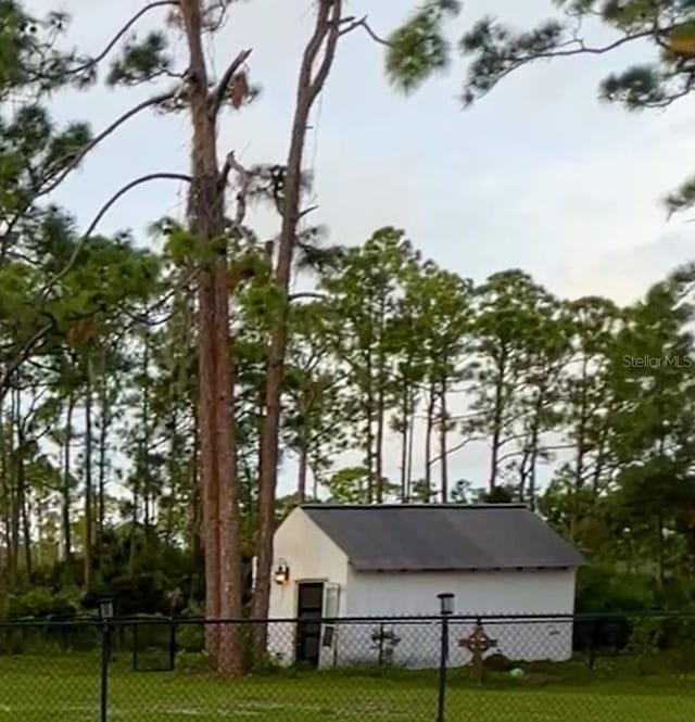 view of outbuilding with a yard