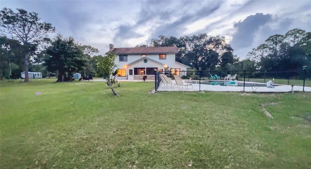 view of yard with a fenced in pool and a patio area