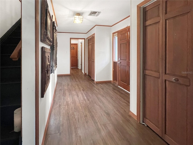 hallway featuring crown molding and hardwood / wood-style flooring