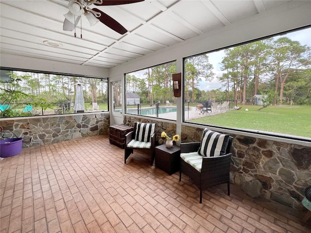 sunroom / solarium featuring ceiling fan