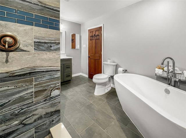 bathroom featuring tile patterned flooring, vanity, toilet, and a tub to relax in