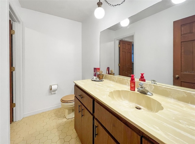 bathroom with vanity, tile patterned floors, and toilet