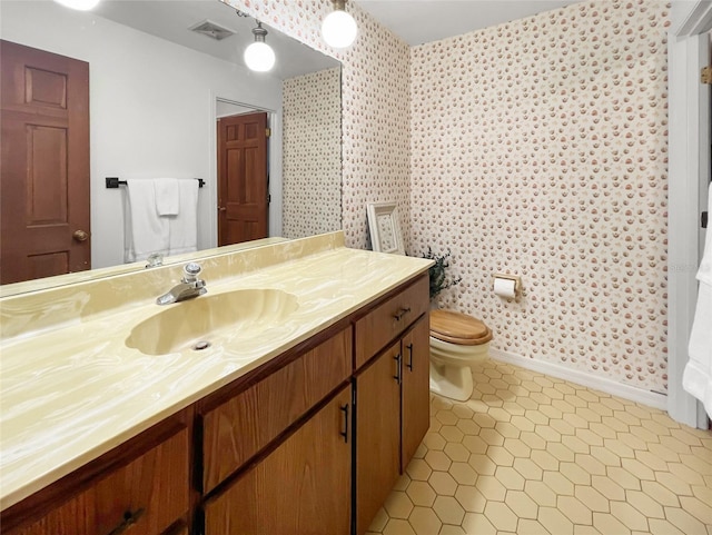 bathroom featuring vanity, toilet, and tile patterned flooring