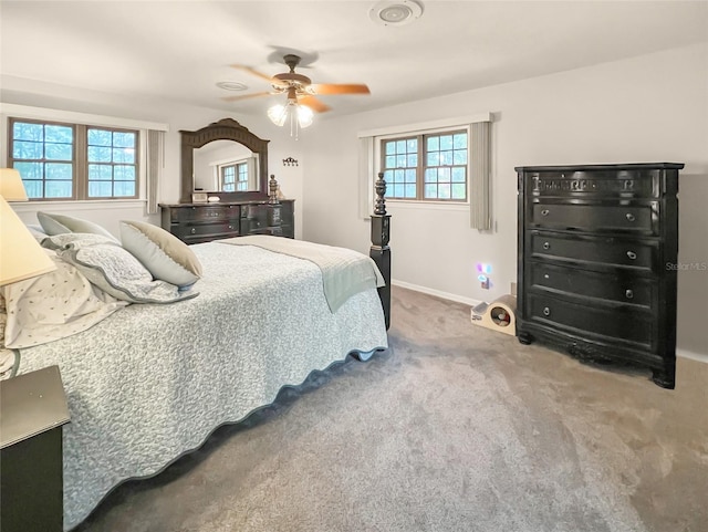 bedroom with carpet, ceiling fan, and multiple windows