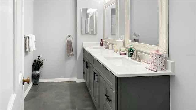 6885 Orchid Tree Dr, Grant, FL 32949 - full bathroom with double vanity, baseboards, and tile patterned floors