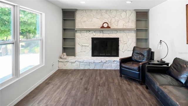6885 Orchid Tree Dr, Grant, FL 32949 - living room featuring wood finished floors, baseboards, and a stone fireplace