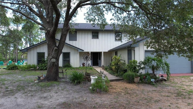 6885 Orchid Tree Dr, Grant, FL 32949 - view of front of home with an attached garage and board and batten siding