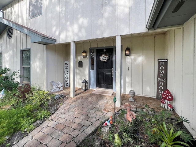 6885 Orchid Tree Dr, Grant, FL 32949 - property entrance featuring board and batten siding and covered porch