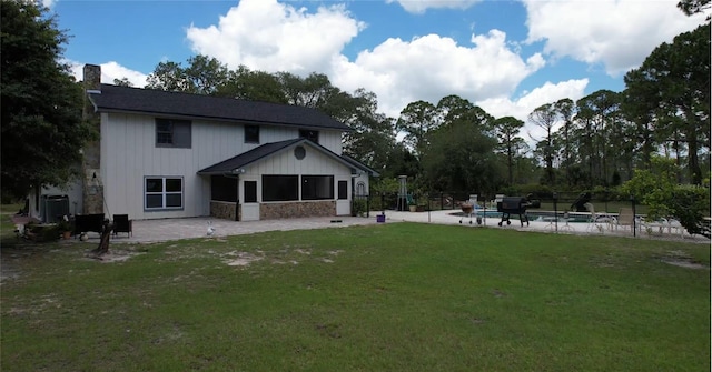 6885 Orchid Tree Dr, Grant, FL 32949 - back of property with a chimney, a patio, and a sunroom