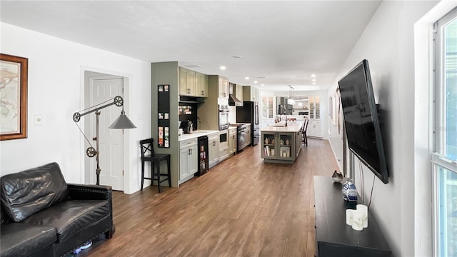 6885 Orchid Tree Dr, Grant, FL 32949 - living area with wood finished floors, wine cooler, and recessed lighting