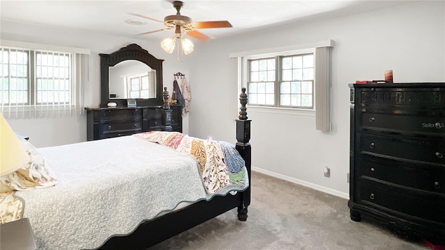 6885 Orchid Tree Dr, Grant, FL 32949 - carpeted bedroom with multiple windows, baseboards, and ceiling fan