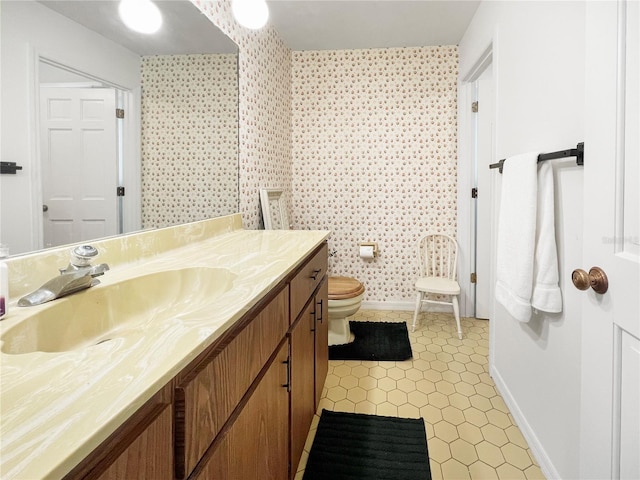 6885 Orchid Tree Dr, Grant, FL 32949 - bathroom featuring vanity, toilet, baseboards, tile patterned flooring, and wallpapered walls