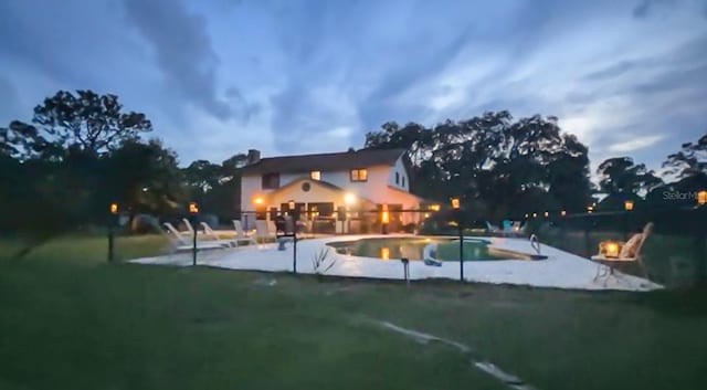 6885 Orchid Tree Dr, Grant, FL 32949 - pool at twilight featuring a patio, a yard, and an outdoor pool