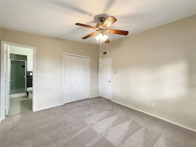 unfurnished bedroom with ceiling fan, carpet floors, connected bathroom, and a closet