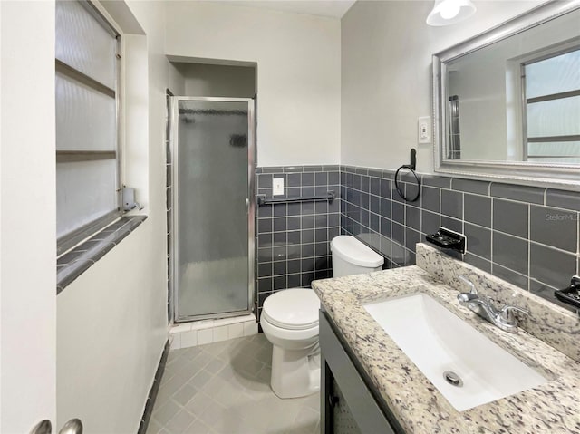 bathroom with walk in shower, tile patterned flooring, toilet, vanity, and tile walls