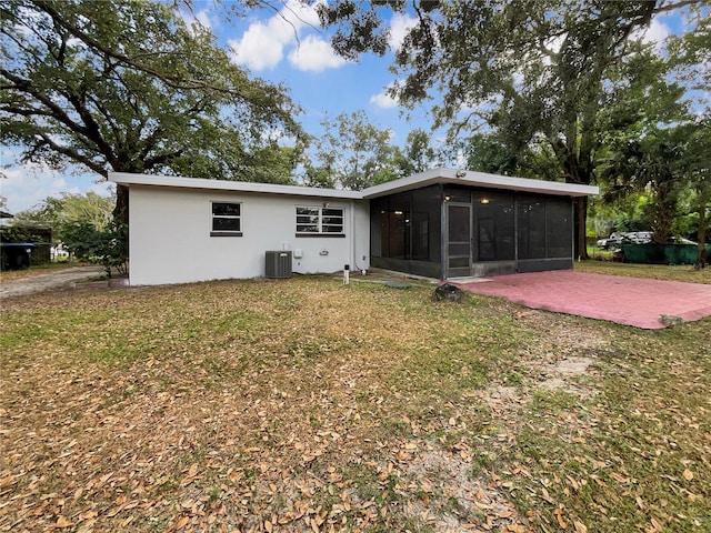 back of house featuring a patio, central AC unit, a lawn, and a sunroom