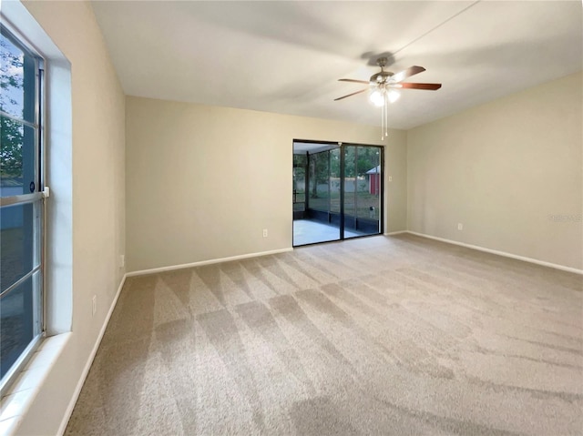 unfurnished room with ceiling fan and carpet floors