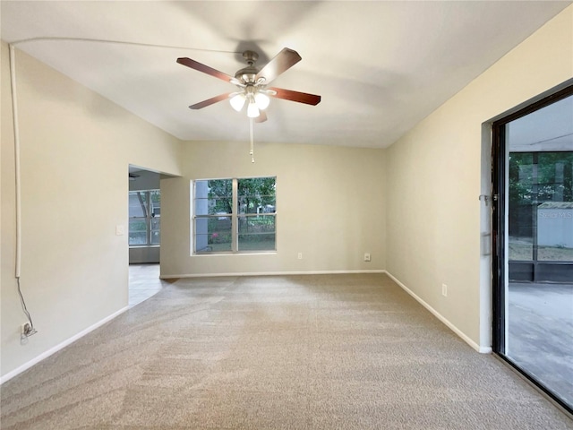 carpeted spare room with ceiling fan