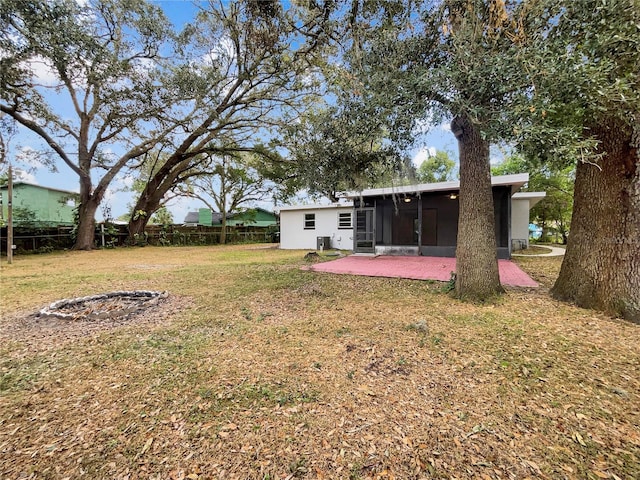 view of yard with a sunroom and a patio area