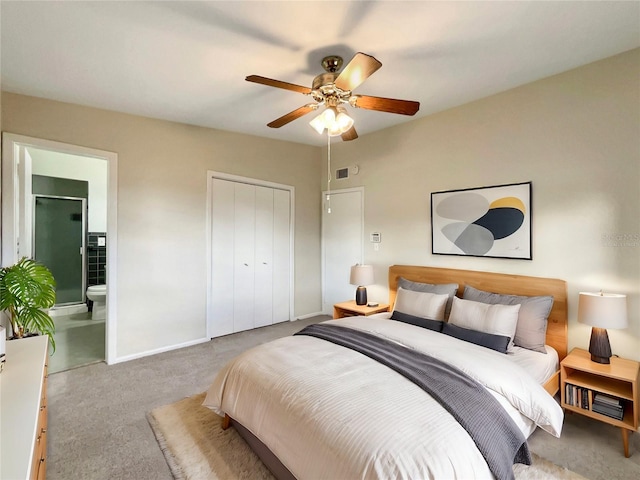 bedroom featuring connected bathroom, ceiling fan, a closet, and light colored carpet