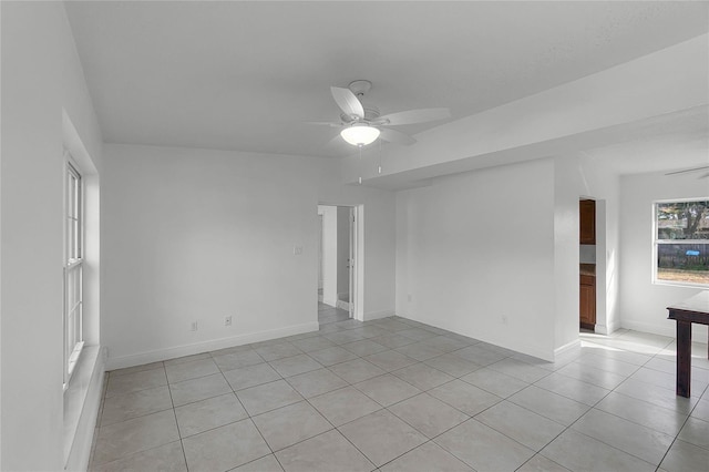 unfurnished room with light tile patterned flooring and ceiling fan