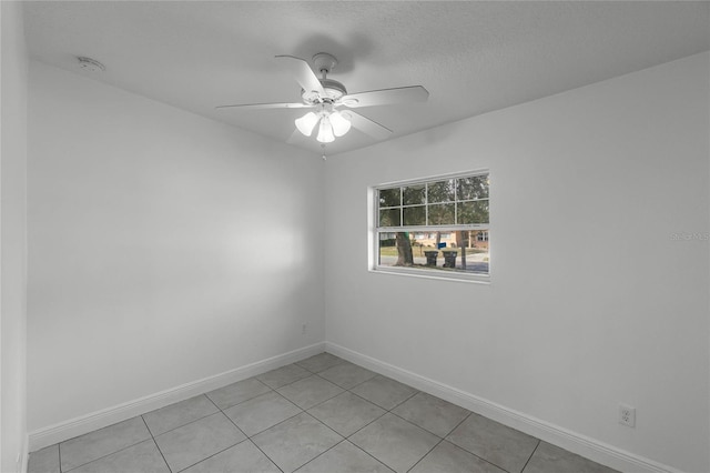 unfurnished room with light tile patterned floors and ceiling fan