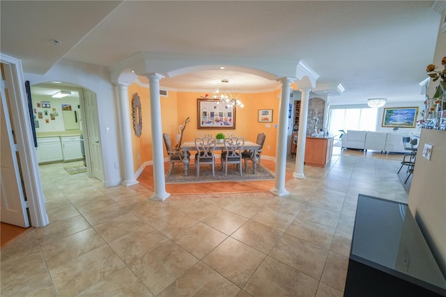 dining room with light tile patterned floors, crown molding, and a chandelier