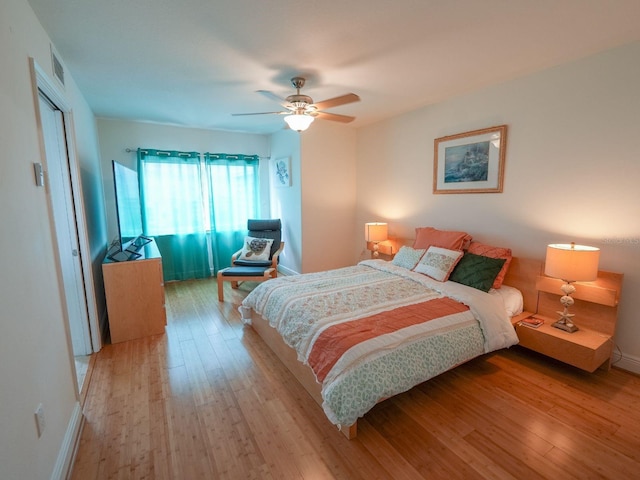 bedroom with light hardwood / wood-style flooring and ceiling fan