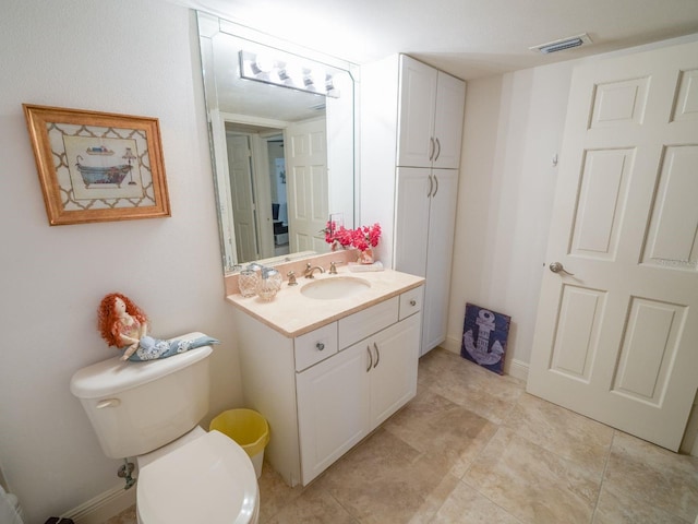 bathroom featuring tile patterned floors, vanity, and toilet