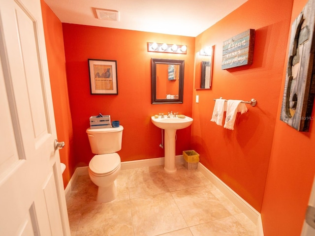 bathroom with tile patterned flooring and toilet