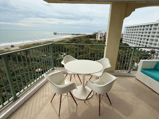 balcony with a beach view and a water view