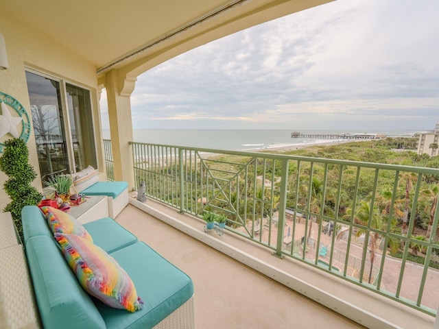 balcony featuring outdoor lounge area and a water view