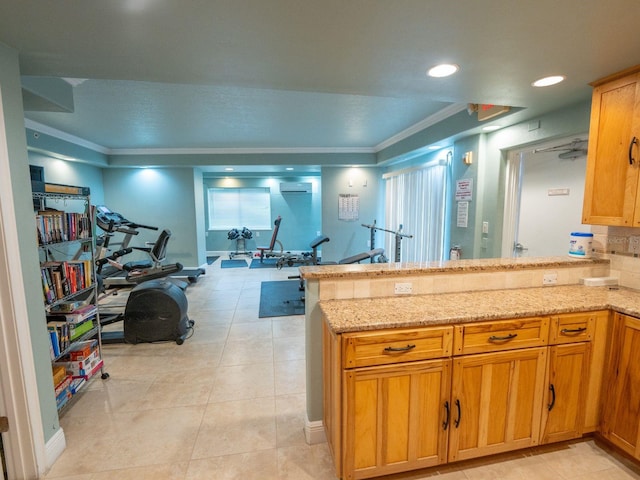 kitchen with kitchen peninsula, crown molding, light tile patterned floors, and light stone countertops