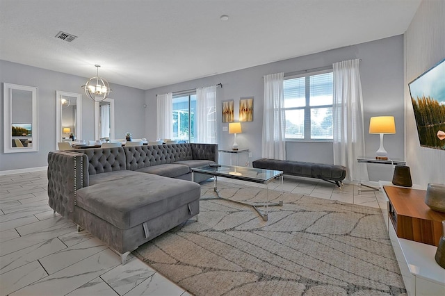 living room with plenty of natural light and a notable chandelier