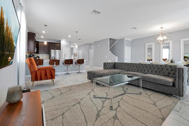 living room featuring a notable chandelier