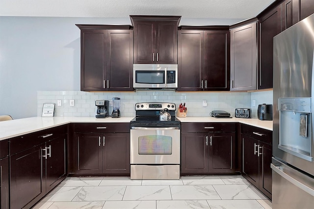 kitchen with tasteful backsplash, dark brown cabinetry, and appliances with stainless steel finishes