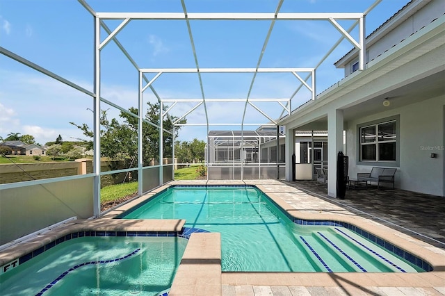 view of pool with glass enclosure and a patio area