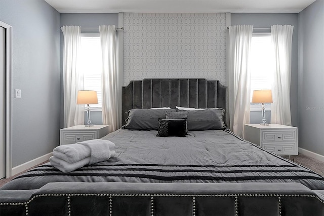 carpeted bedroom featuring multiple windows